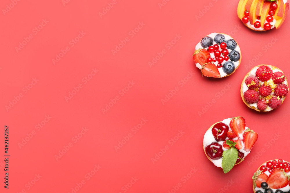 Tasty berry tartlets on color background