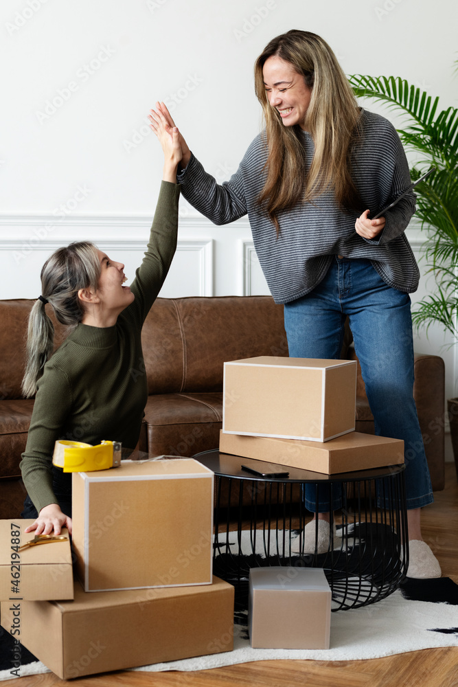 Small business friend partners packing product parcels for delivery