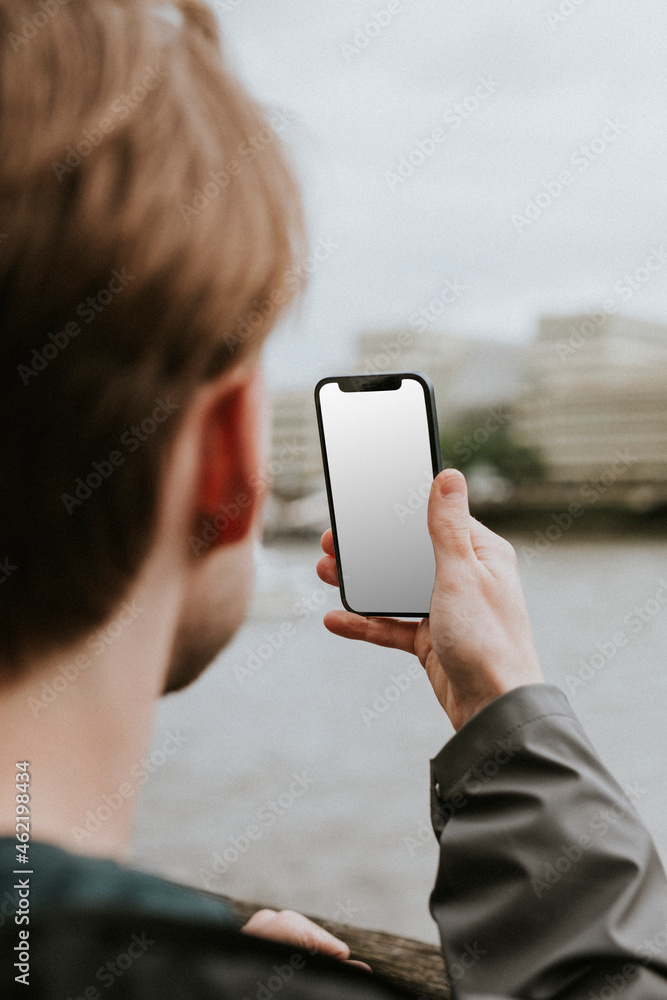 一个男人看着一个空白的智能手机屏幕