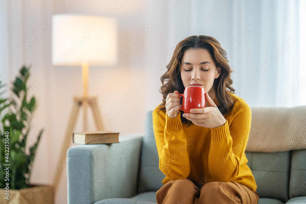 坐在沙发上喝茶的女人