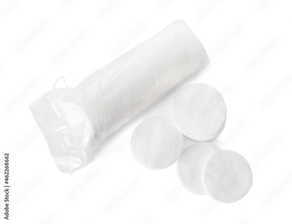 Many round cotton pads on white background