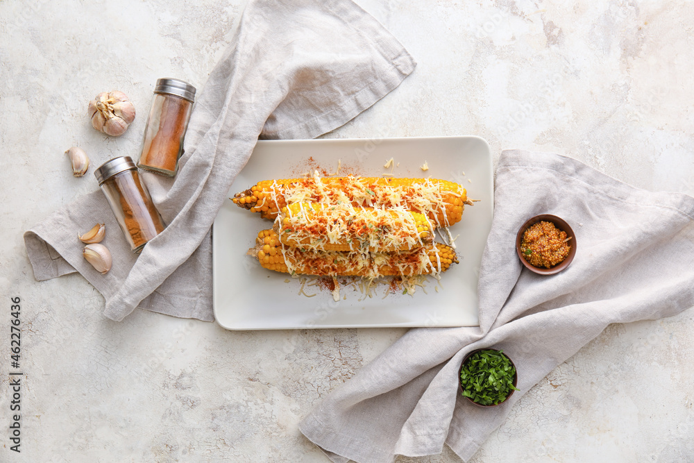 Plate with delicious Elote Mexican Street Corn on light background