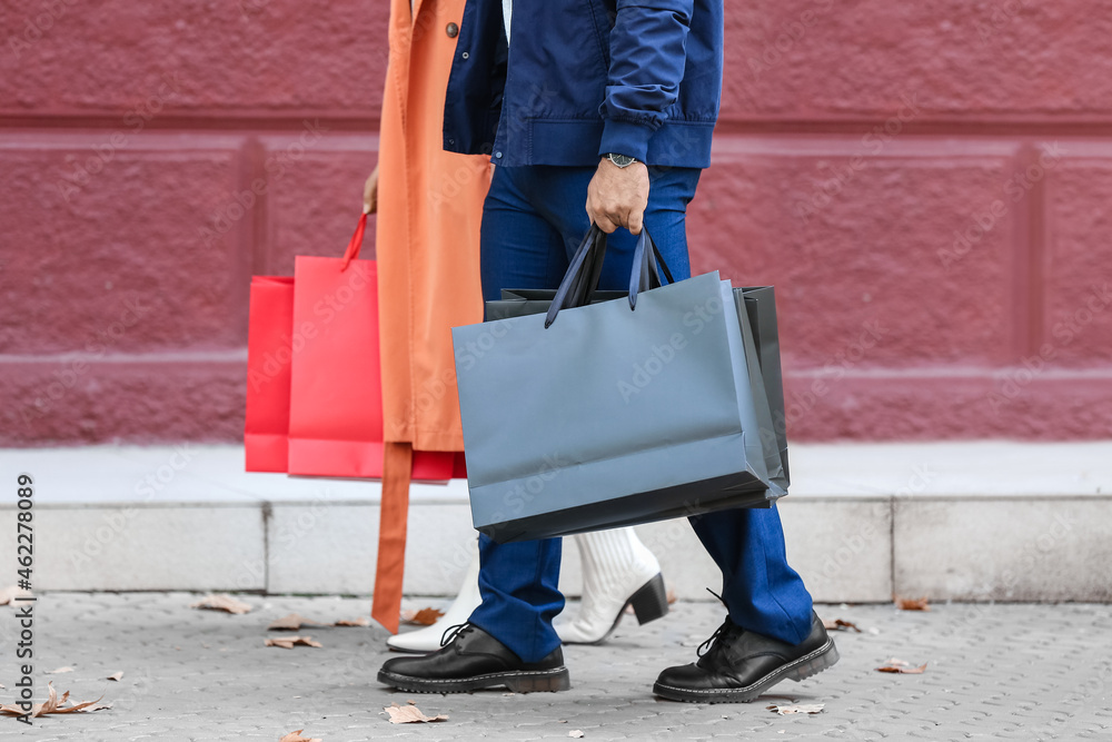 Couple with shopping bags on city street