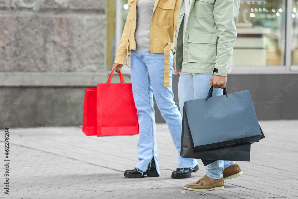 Couple with shopping bags on city street