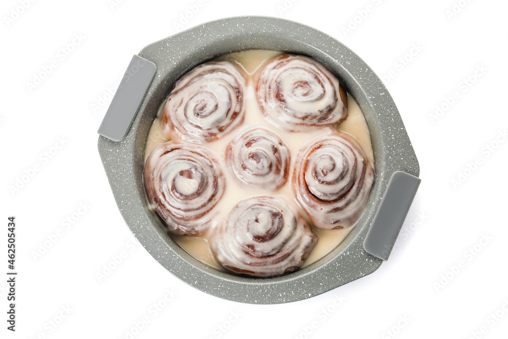 Baking dish with tasty cinnamon rolls on white background