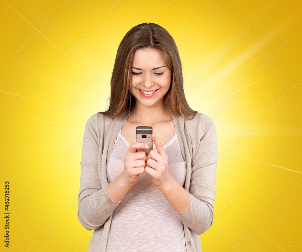 Scared woman holding mobile phone seeing bad news, photos or message