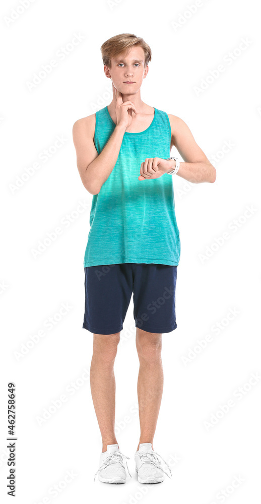 Sporty male runner checking pulse on white background