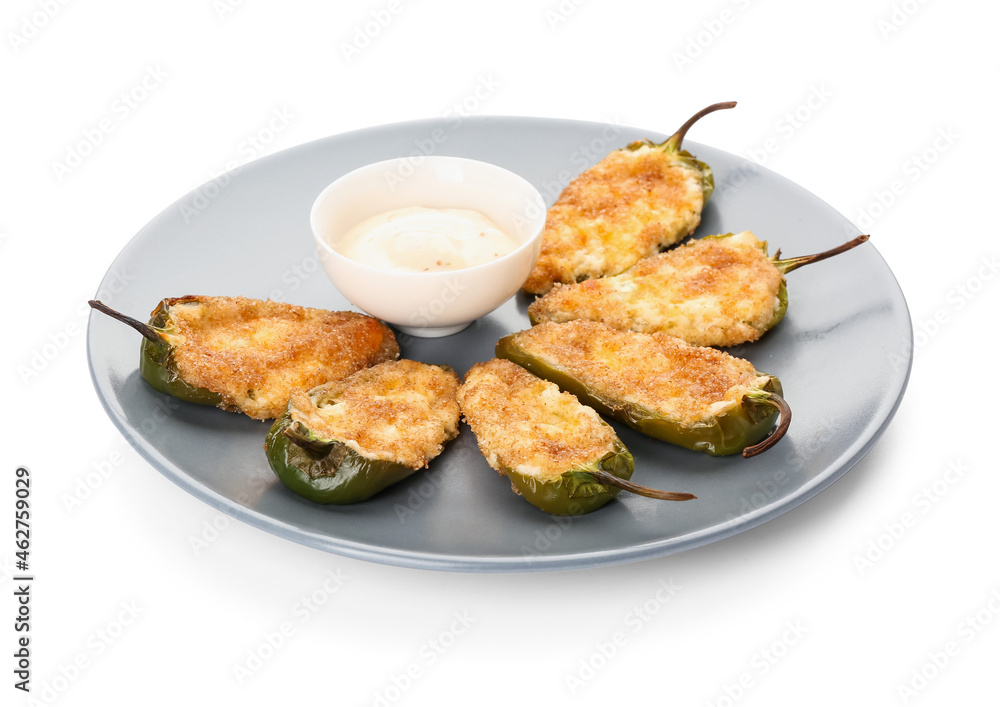 Plate with tasty jalapeno poppers and sauce on white background