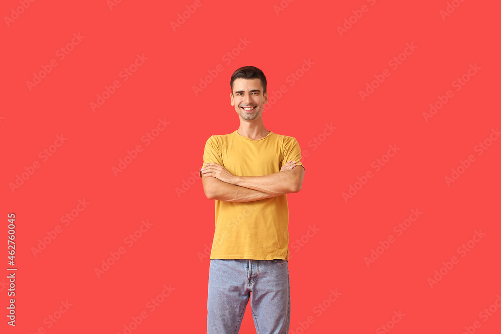 Handsome young man in stylish t-shirt on color background