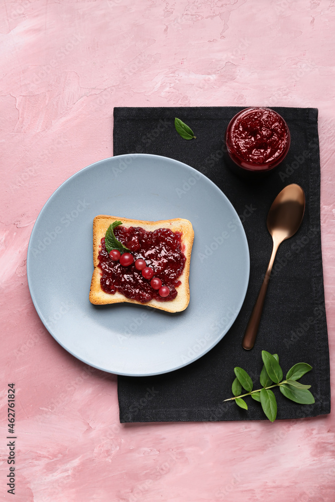 Plate with tasty toast and cranberry jam on color background