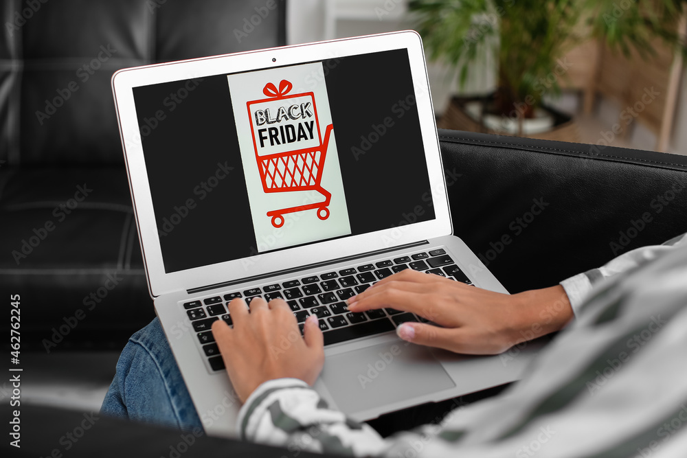 Young woman shopping online on Black Friday at home