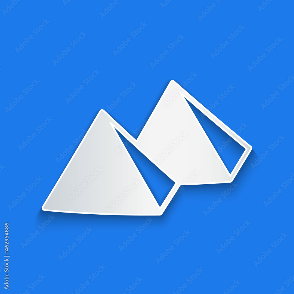 Paper cut Egypt pyramids icon isolated on blue background. Symbol of ancient Egypt. Paper art style.