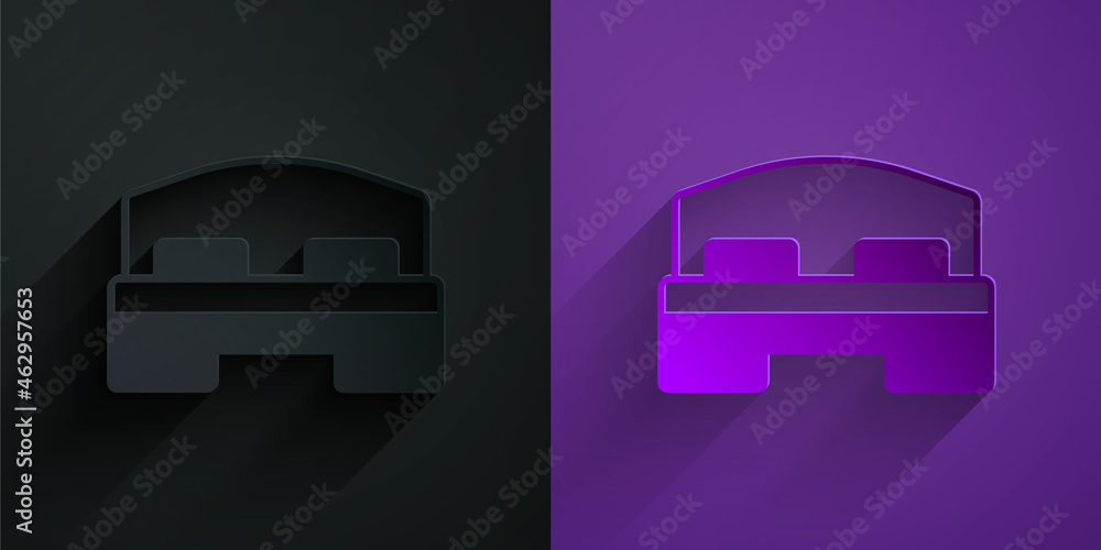 Paper cut Hotel room bed icon isolated on black on purple background. Paper art style. Vector