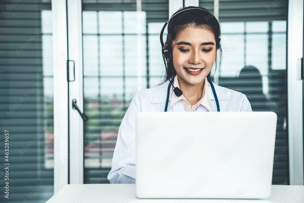 Doctor wearing headset talking actively on video call in hospital or clinic . Concept of telehealth 