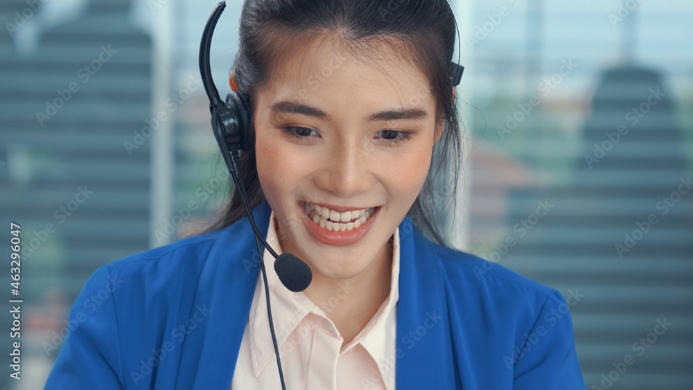 Businesswoman wearing headset working actively in office . Call center, telemarketing, customer supp