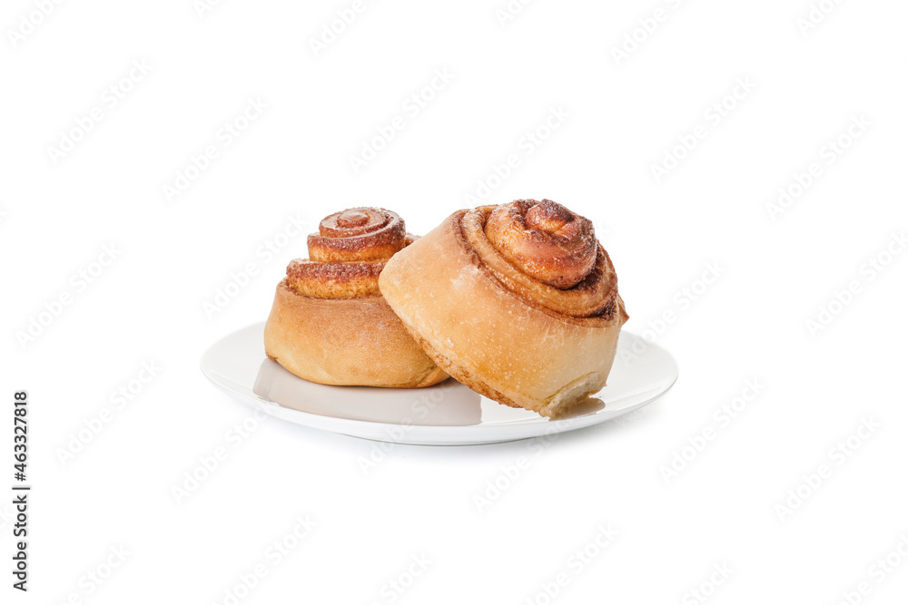 Plate with traditional cinnamon rolls on white background