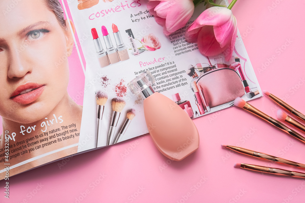 Bottle of perfume, magazine and makeup brushes on color background, closeup