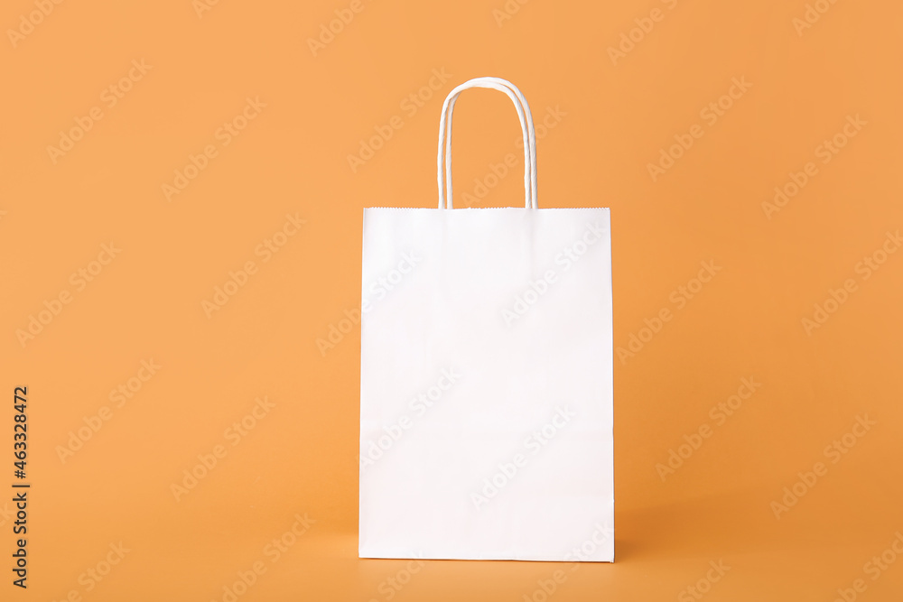 Blank paper bag on color background