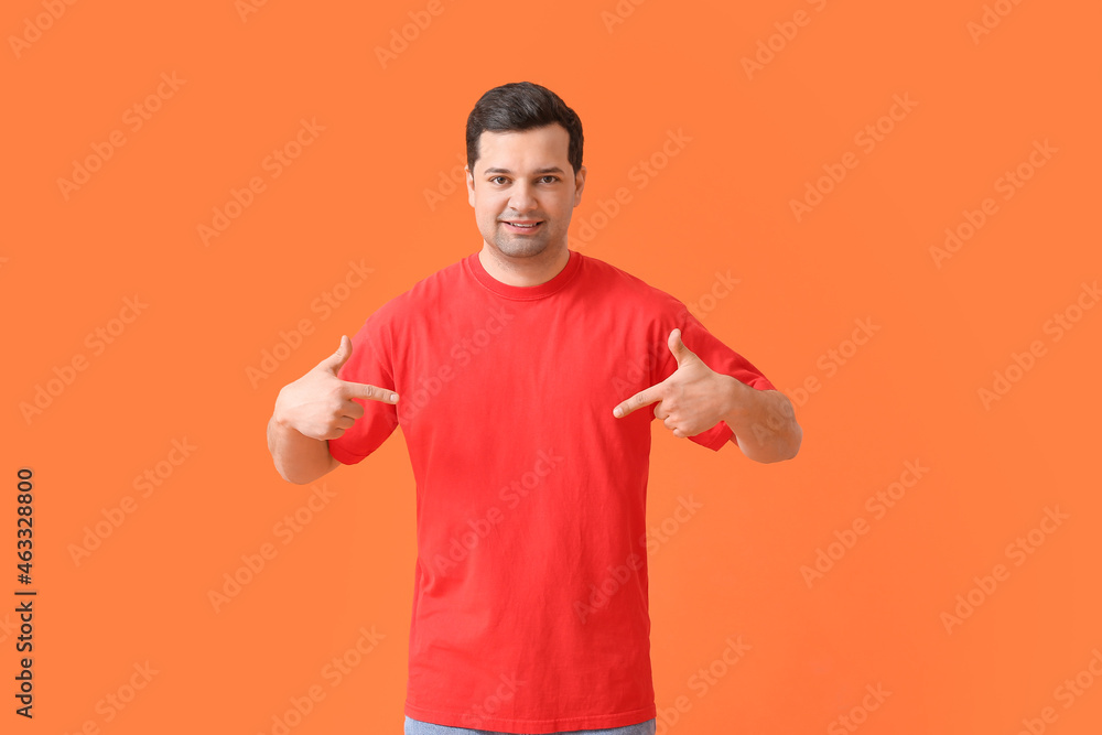 Handsome young man in stylish t-shirt on color background