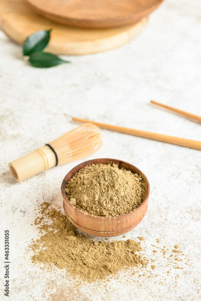 Bowl with hojicha powder on light background