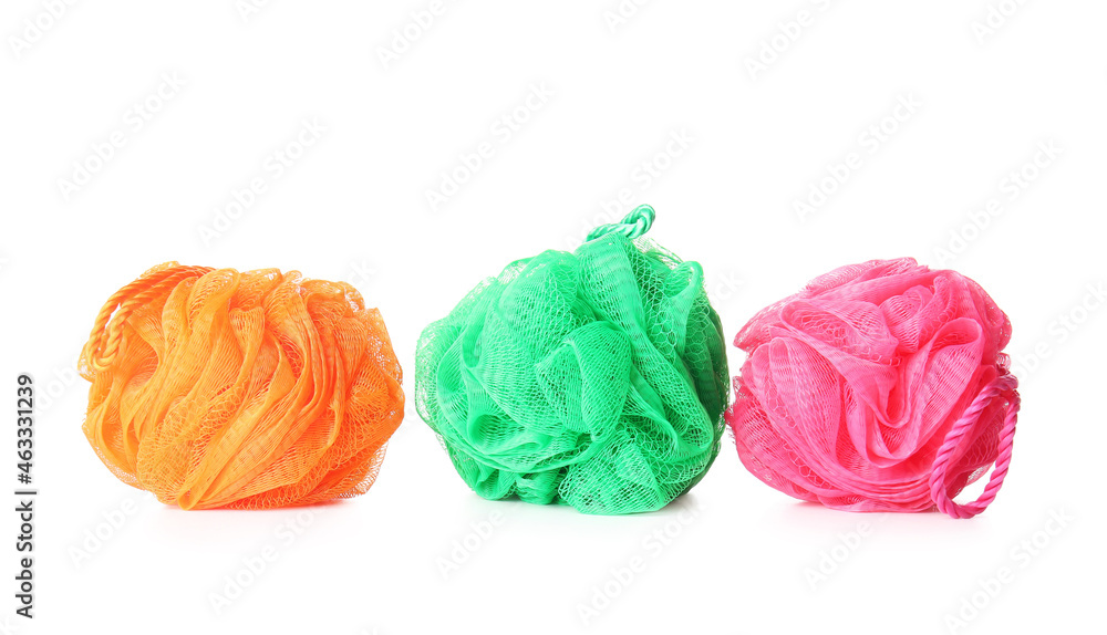 Different bath sponges on white background