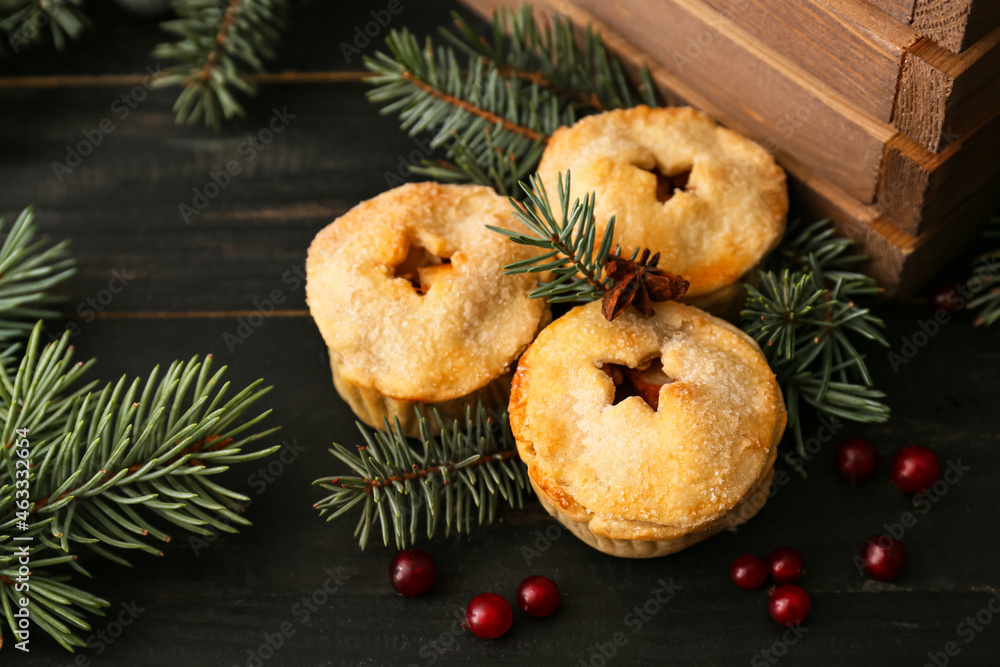 Tasty mince pies on dark table