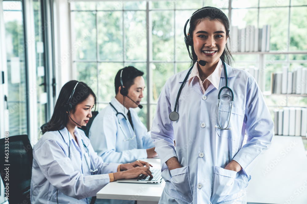 Doctor team wearing headset talking actively on video call in hospital clinic . Concept of telehealt