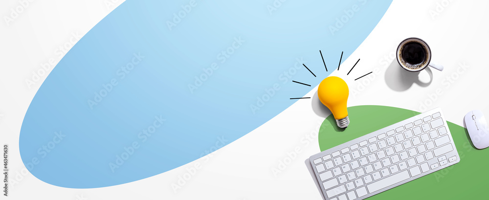 Computer keyboard with a yellow light bulb from above