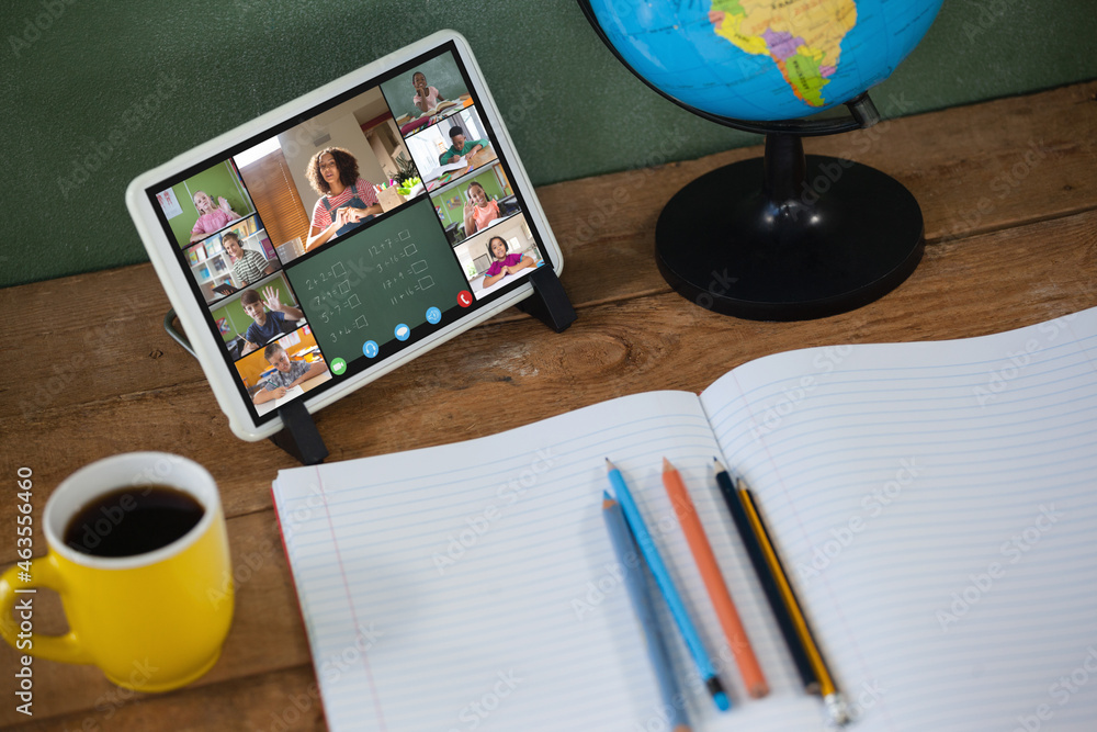 Smiling diverse elementary school pupils during class on tablet screen