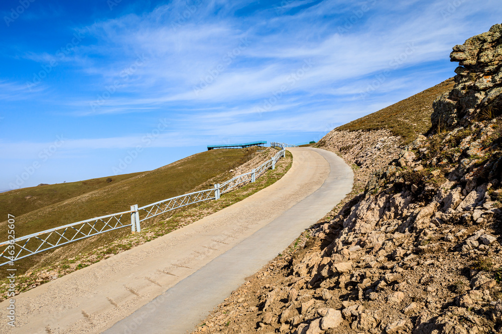 Curved road and mountain natural scenery in autumn season.Road and mountain background.