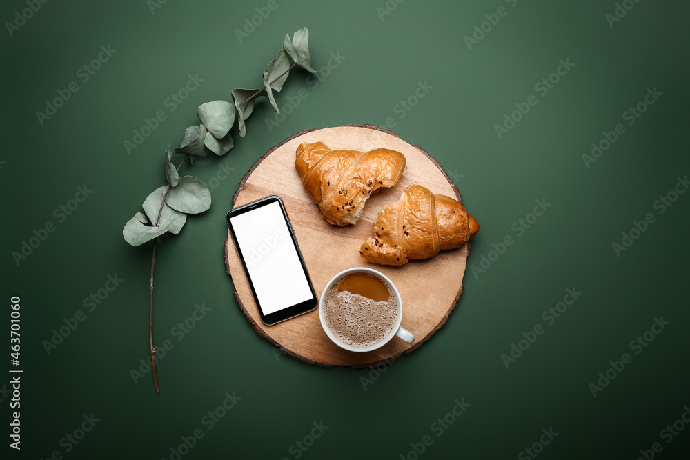 Composition with cup of coffee, tasty croissant and mobile phone on color background