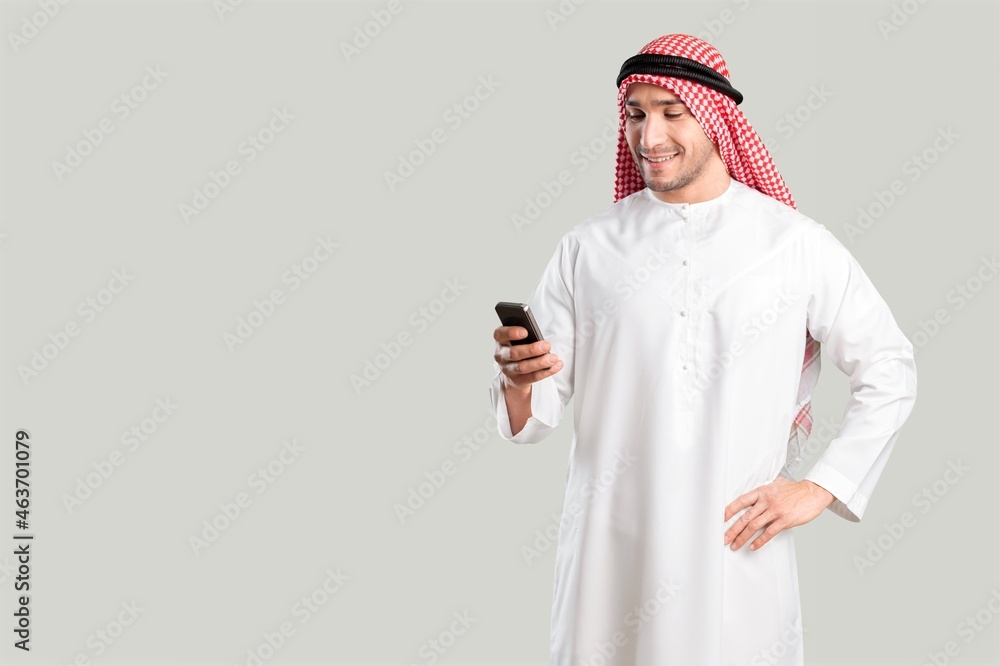 Saudi young arabian man holding a digital gadget