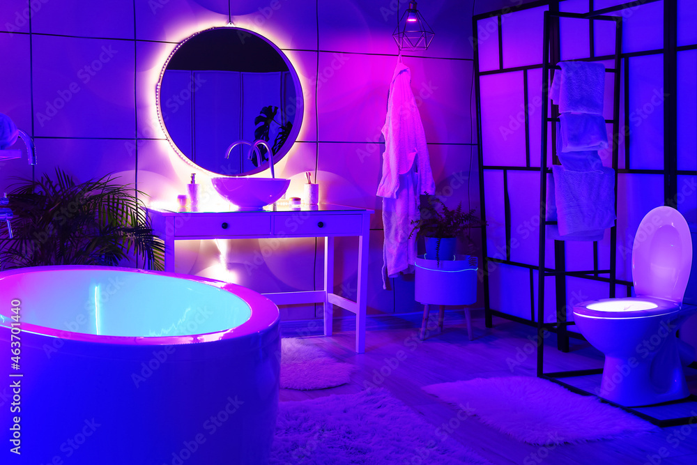 Interior of stylish bathroom with neon lighting