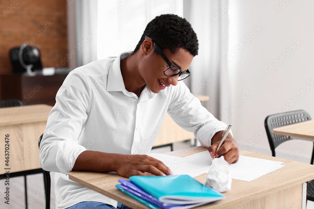 African-American student passing exam at school