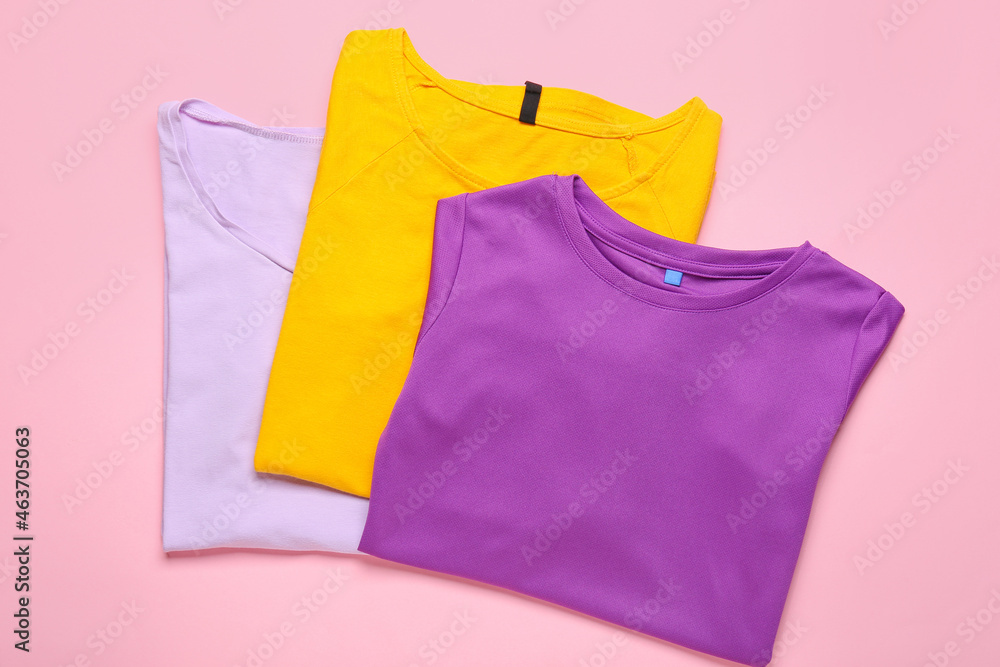 Different t-shirts on pink background