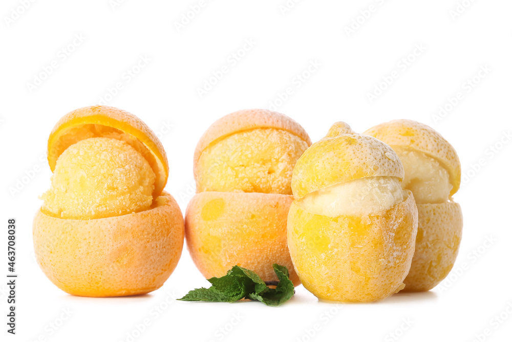 Tasty ice creams in citrus fruit peels on white background