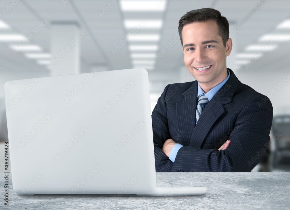 Emotional glad young employee looking at laptop screen, feeling excited