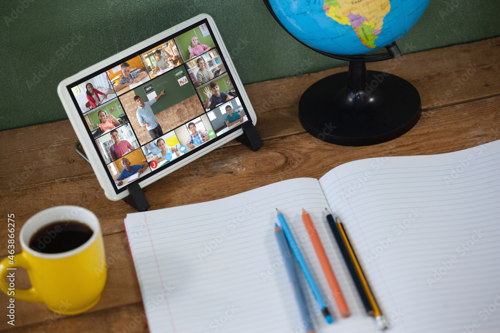 Smiling diverse elementary school pupils during class on tablet screen