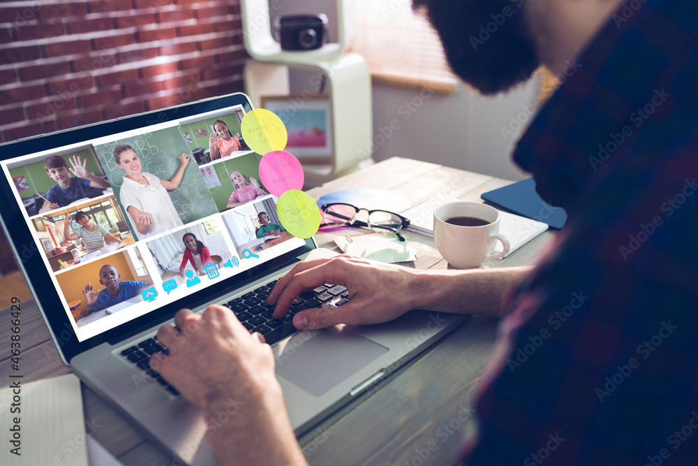 Caucasian man using laptop for video call, with smiling diverse elementary school pupils on screen