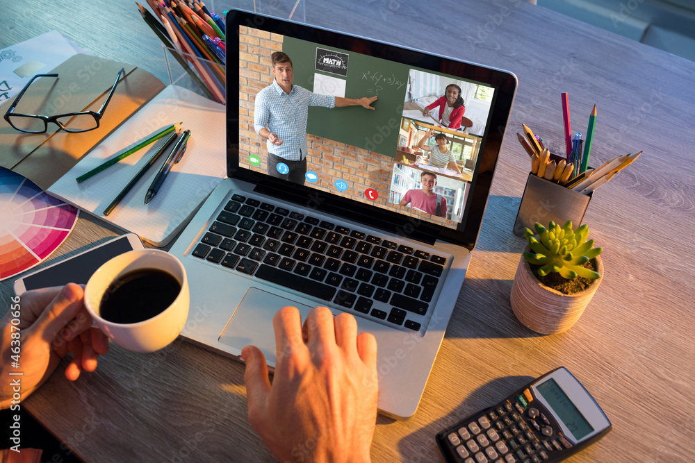 Hands of man using laptop for video call, with smiling diverse elementary school pupils on screen