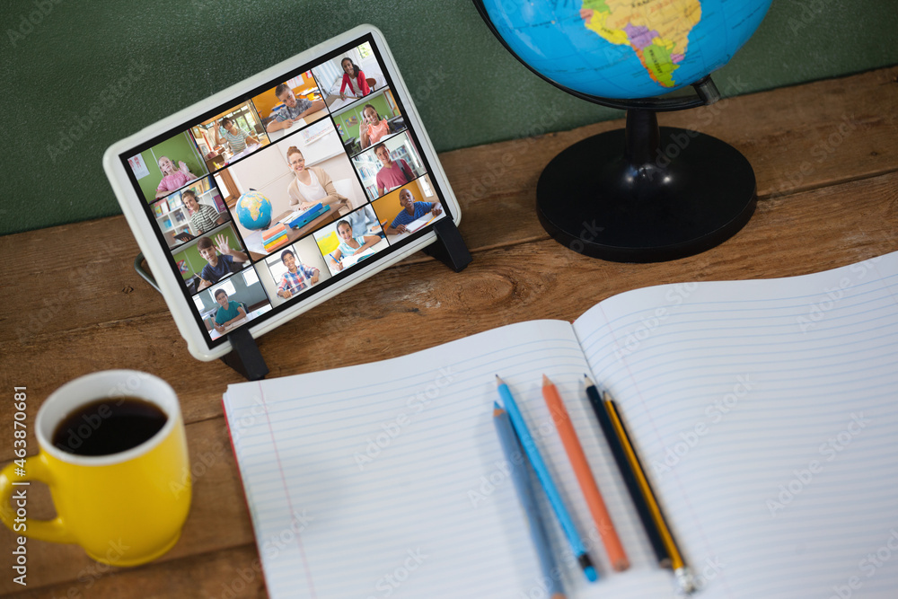 Smiling diverse elementary school pupils during class on tablet screen