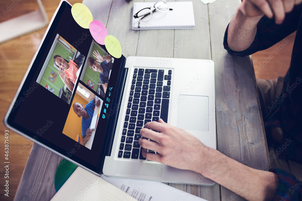 Hands of man using laptop for video call, with smiling diverse elementary school pupils on screen