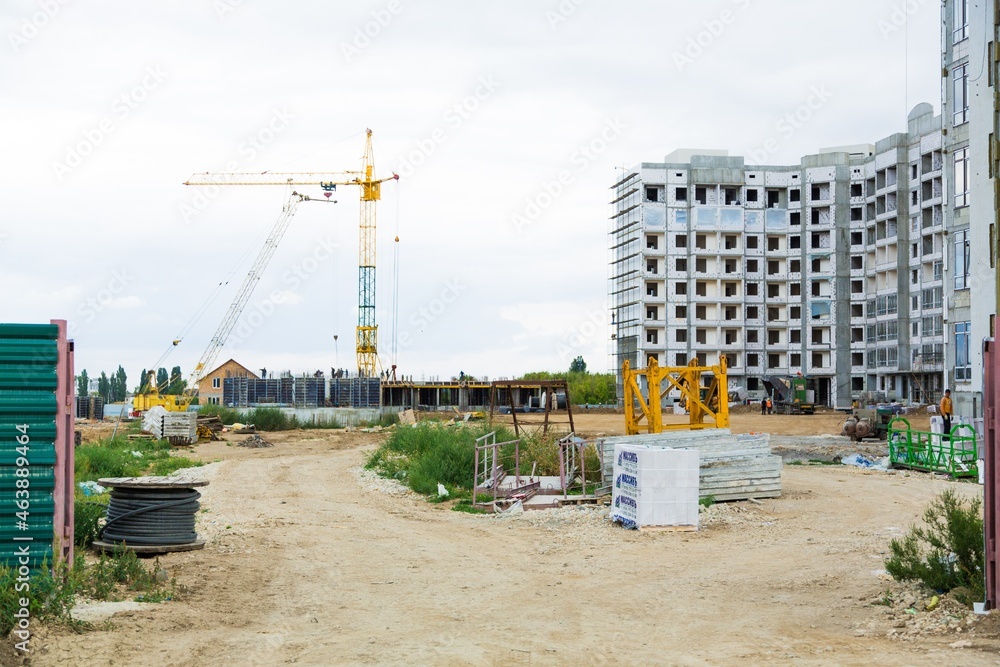 大型建筑工地，包括在建筑群上工作的几台起重机，天空晴朗