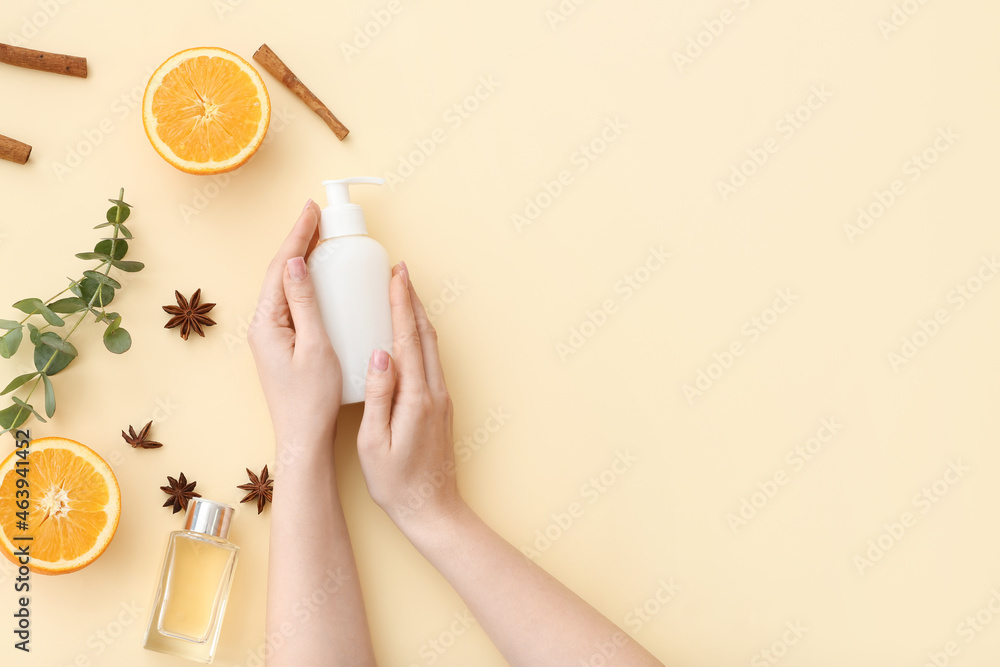 Female hands with bottle of cosmetic product on light background