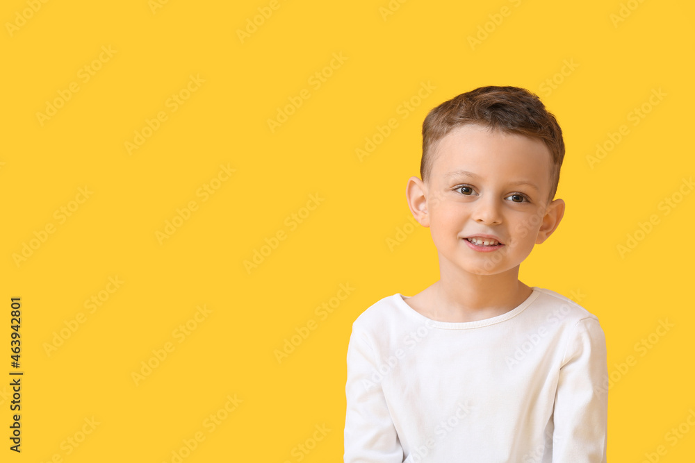 Portrait of happy little boy on color background