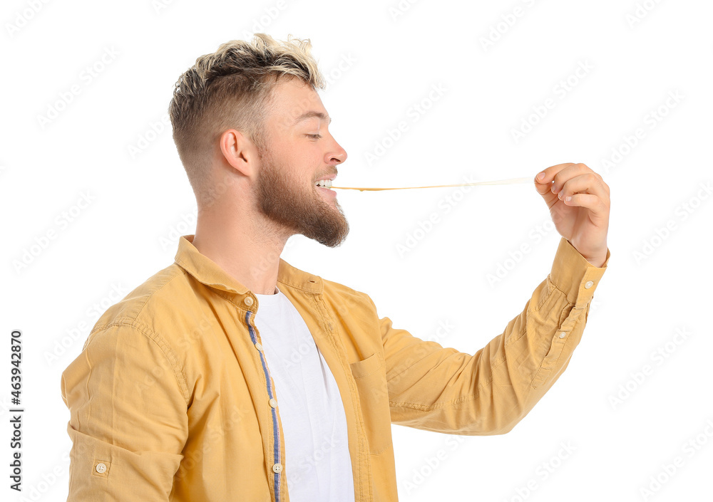 Young man with chewing gum on white background