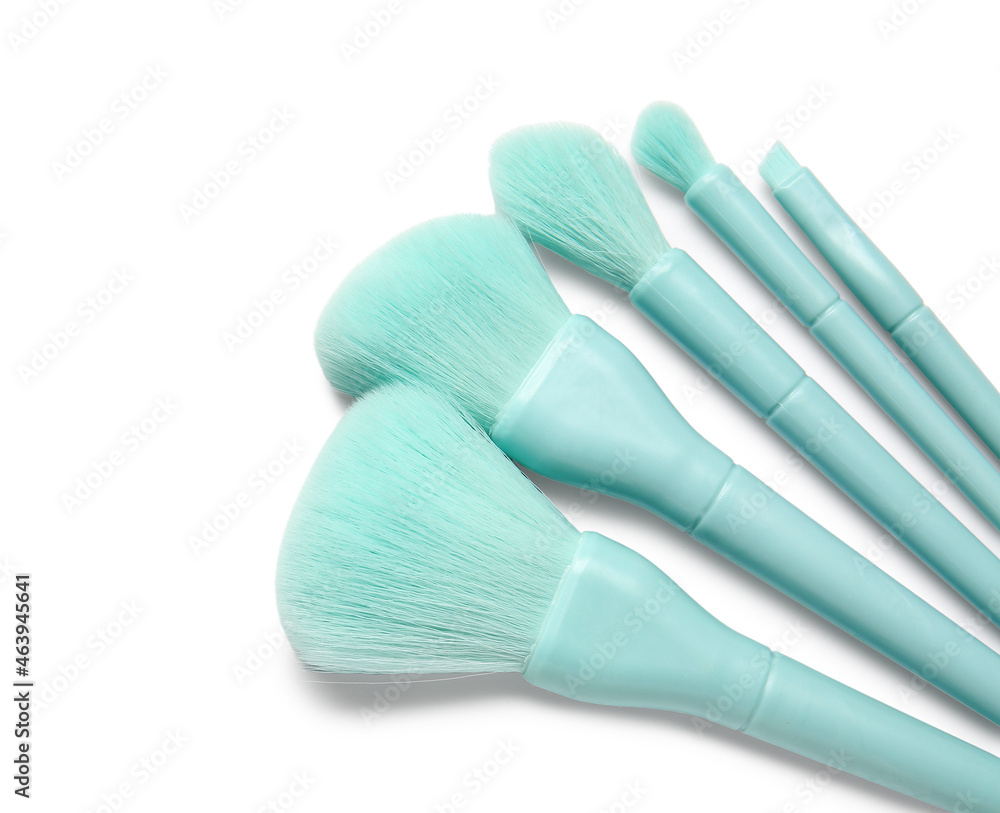 Set of stylish makeup brushes on white background