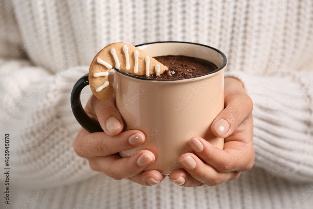 Woman holding cup of tasty hot chocolate, closeup