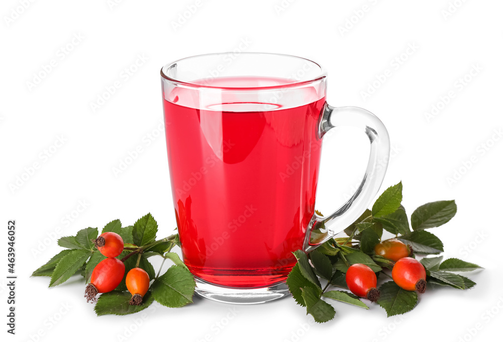 Glass cup of tasty rose hip tea and berries on white background