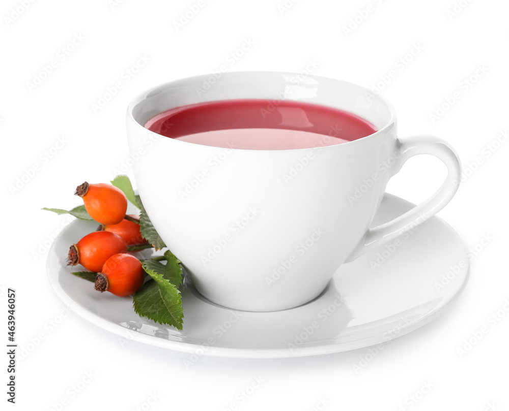 Cup of tasty rose hip tea and berries on white background